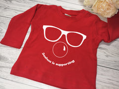Personalised Red nose day face BABY RED long sleeve t-shirt with Name is supporting detail