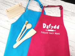 Personalised children's Welsh Pobydd bach apron in pink or blue