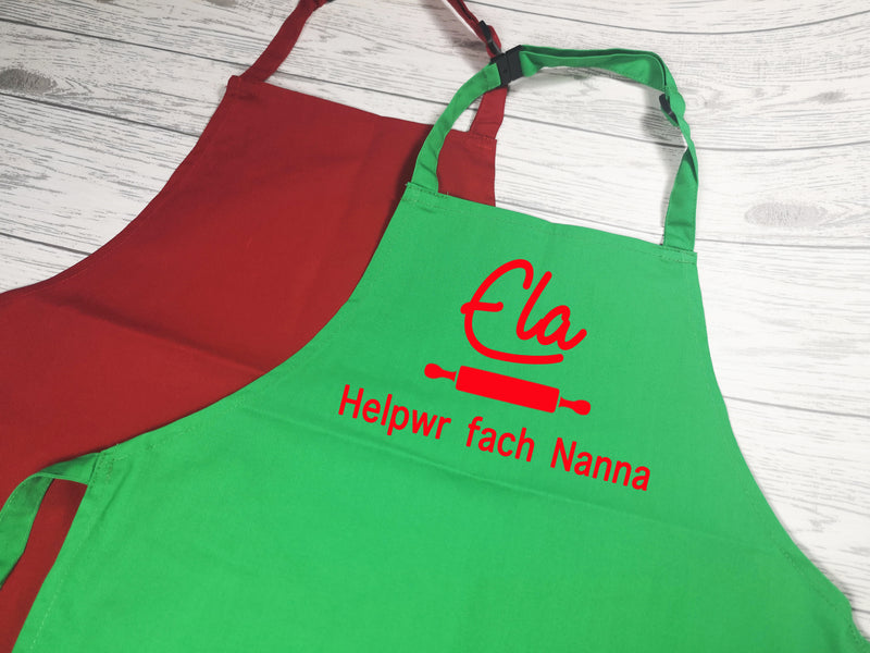 Personalised children's Welsh Helpwr bach / fach apron in red or green