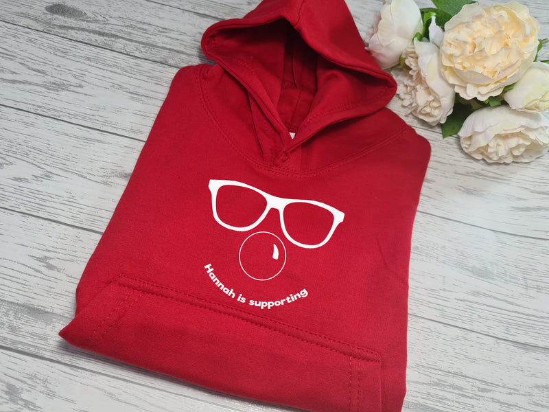 Personalised Red nose day face kids RED hoodie with Name is supporting detail